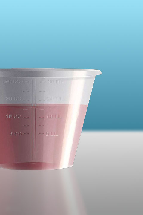 A plastic cup of red liquid methadone for substance abuse treatment